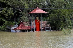 A flooded Buddhist temple is seen on the side of a flooded road in Bulathsinhala village, in Kalutara