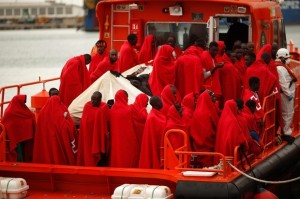 Migrants stand on a rescue boat upon arrival at the port of Malaga